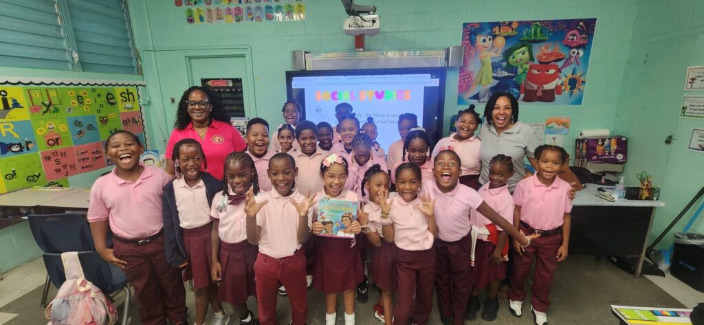 Children in a classroom taking a group picture.